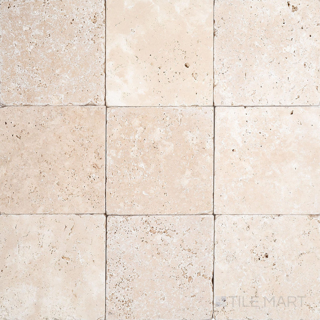 Overview of Ivory Premium Travertine 4x4 Tumbled Tile with soft, worn edges and a naturally aged surface texture.