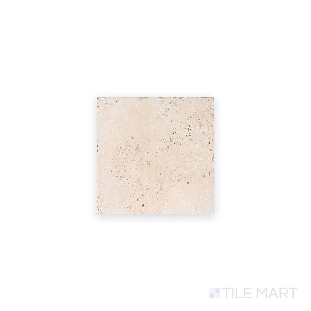 Top-down view of Ivory Premium Travertine 6x6 tumbled tile, featuring rustic surface variation and classic stone charm in a warm beige palette.