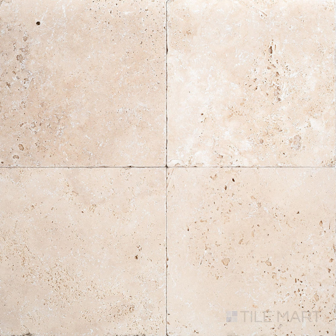 Full view of Ivory Premium Travertine 18x18 Tumbled Tile displaying a classic square format with rich ivory tones and a timeworn look.