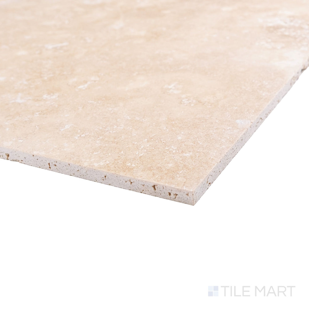 Corner detail of Vera Cruz travertine 12x24 tile highlighting honed finish and gentle stone movement