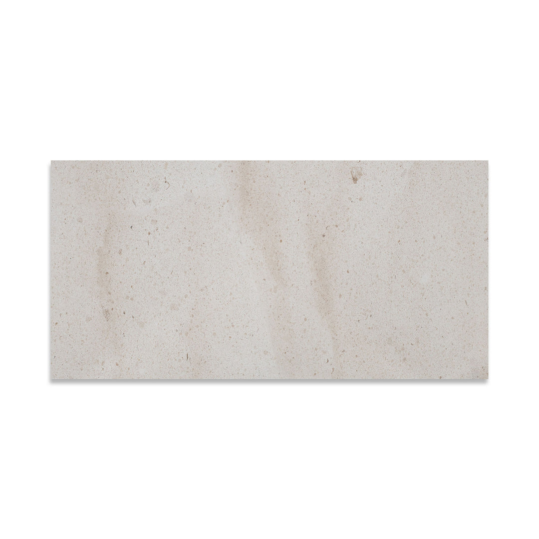 Crema Europa Limestone 12x24 tile in honed finish viewed from above, showcasing light beige color with fine natural movement and a smooth matte surface.
