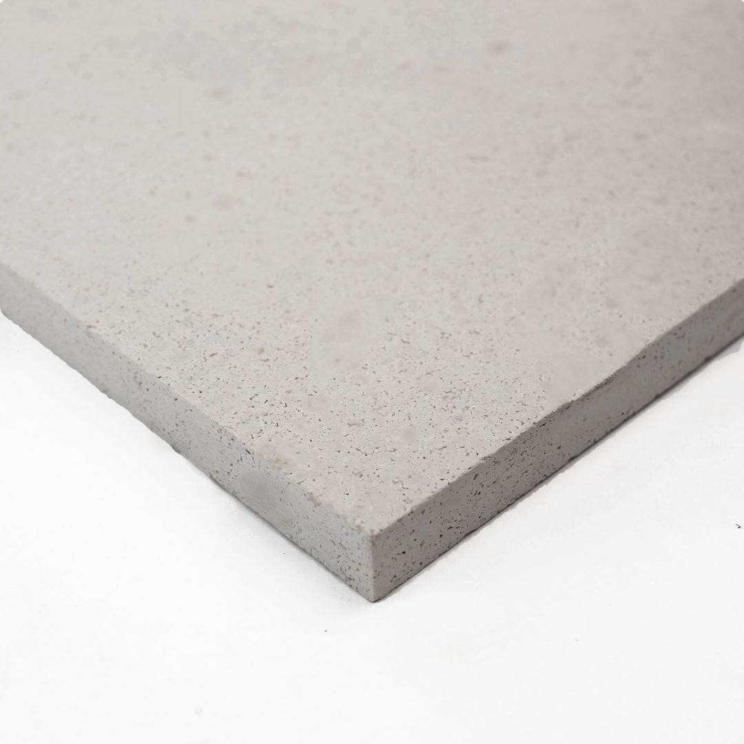 Corner view of Crema Europa Limestone 24x24 Honed Tile, showcasing its soft beige tones and smooth finish—perfect for sophisticated floor and wall designs.