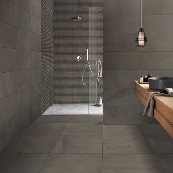 Modern bathroom with gray tiles and a wooden sink.