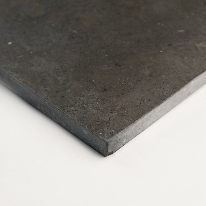 Lagos Blue Limestone 24x24 Honed Tile from a corner angle, revealing its bold stone character and balanced square format suited for luxury interior surfaces.