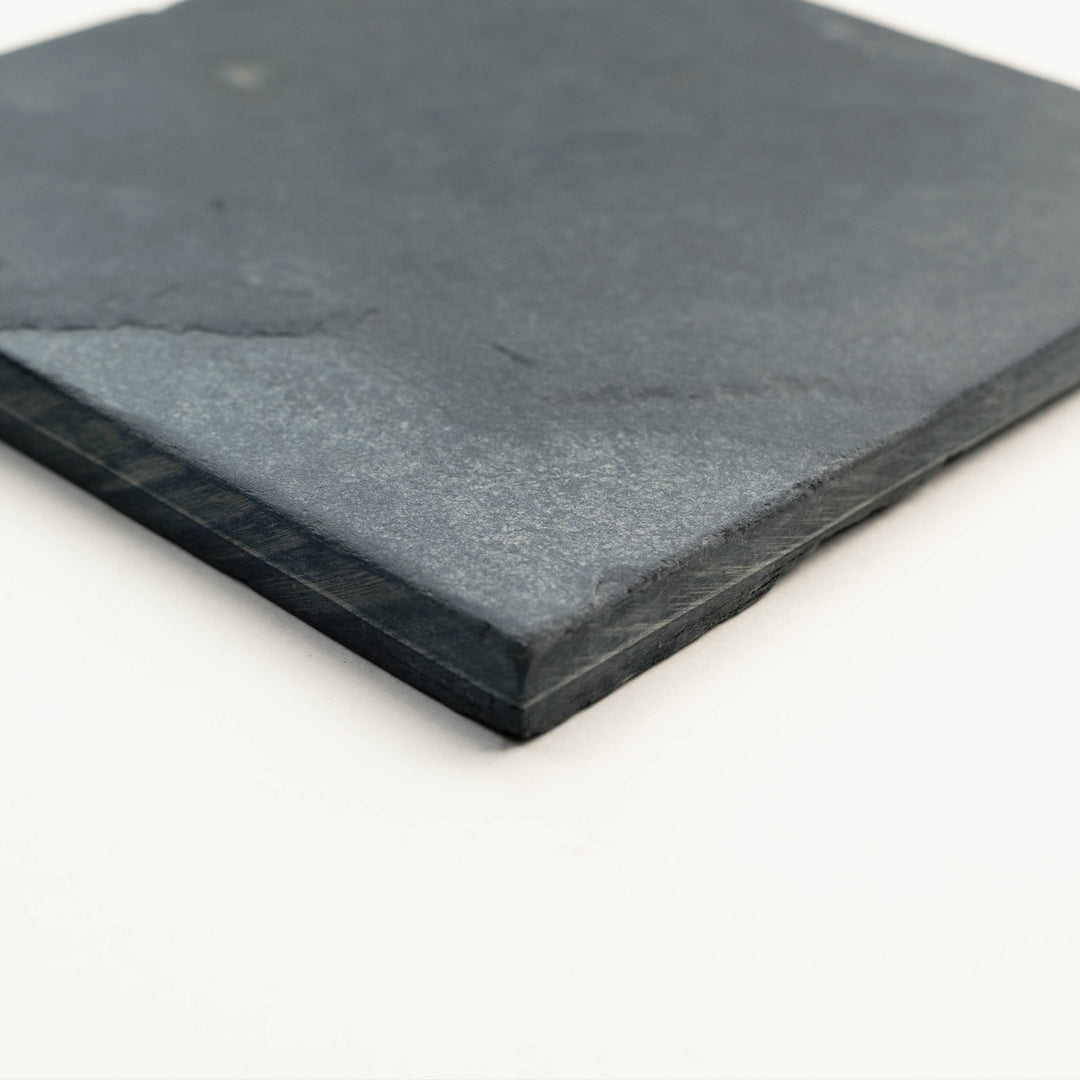 Corner shot of Indian Black Slate 3x6 Tumbled Tile, showcasing its rustic surface and deep charcoal tones ideal for classic backsplashes and feature borders.