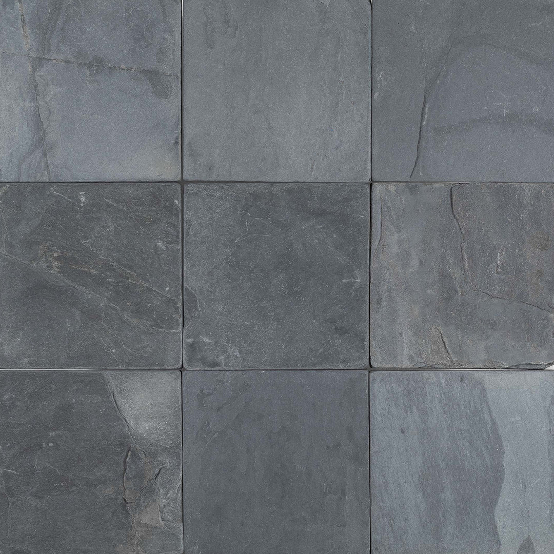 Clean view of Indian Black Slate 4x4 Tumbled Tile highlighting the natural texture and aged surface of square-cut black slate.