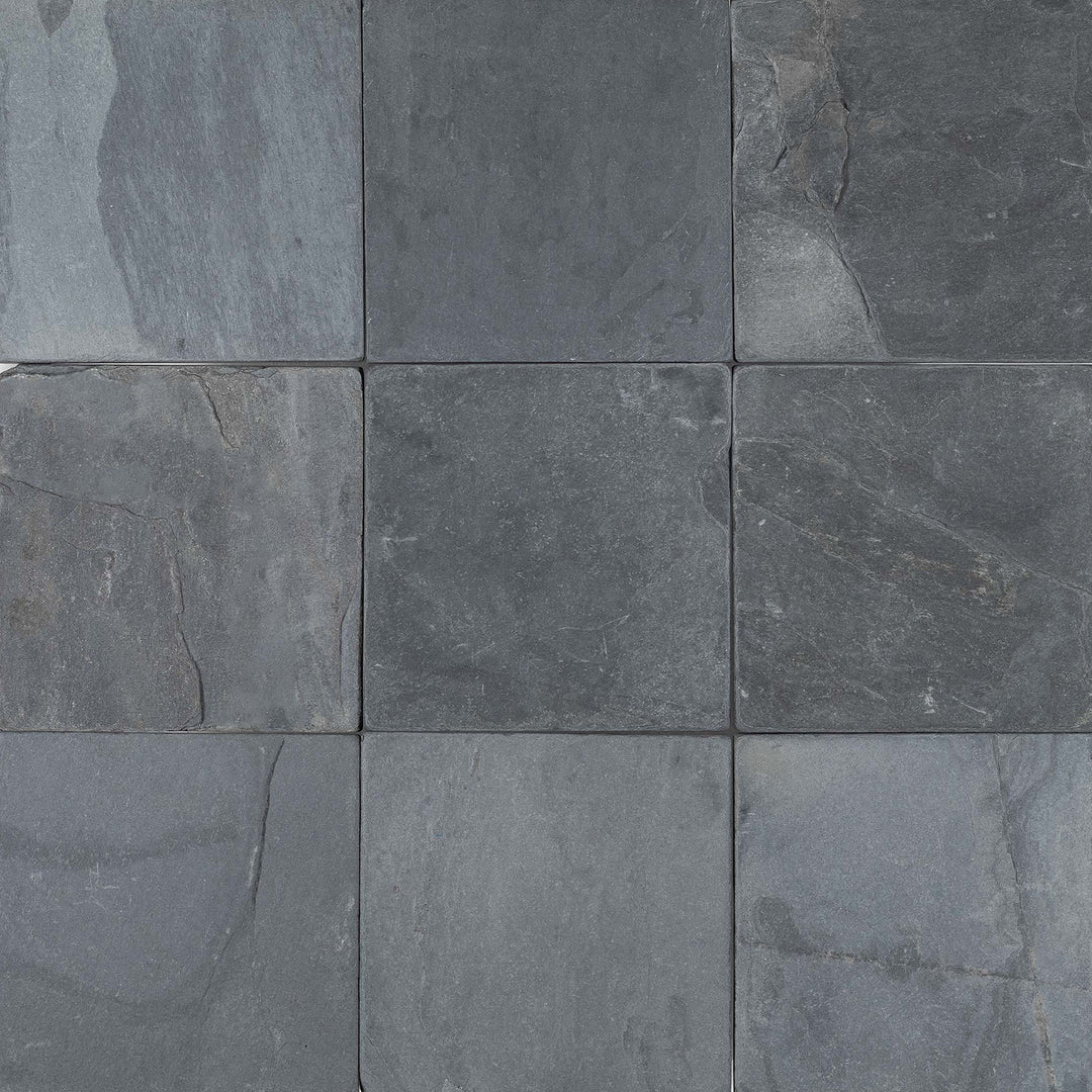 Overview of Indian Black Slate 6x6 Tumbled Tile displaying a timeworn matte finish and consistent dark tones in square format.