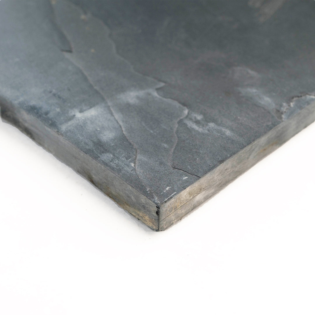 Indian Black Slate 12x24 Gauged Tile photographed at an angle, showing off its sleek rectangular format and subtly varied slate texture for stylish interiors.