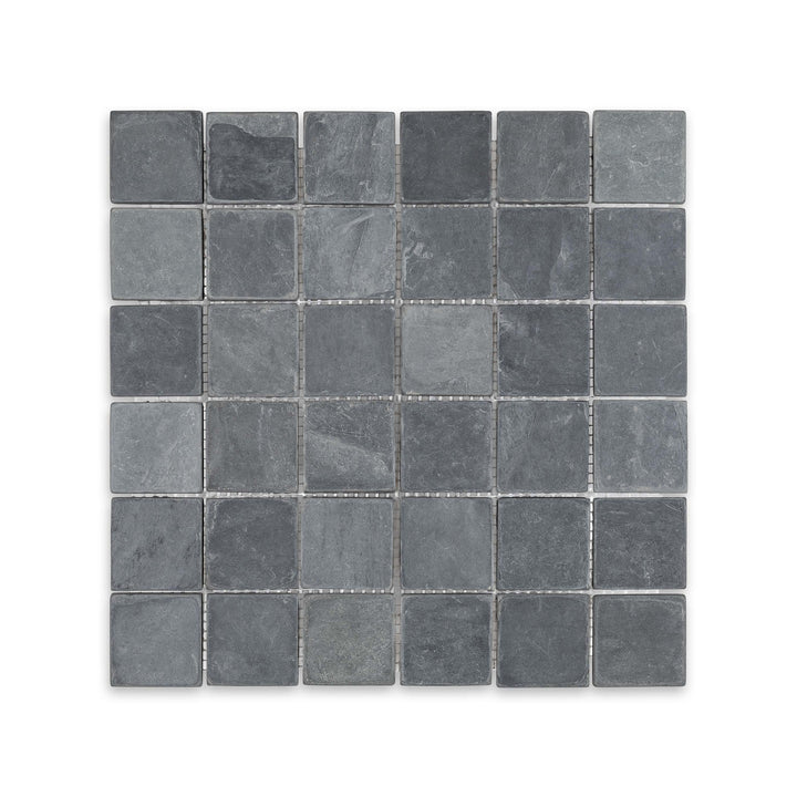 Top-down view of Indian Black Slate 2 inch square mosaic in tumbled finish, highlighting rugged texture and deep black tones in a classic grid layout.