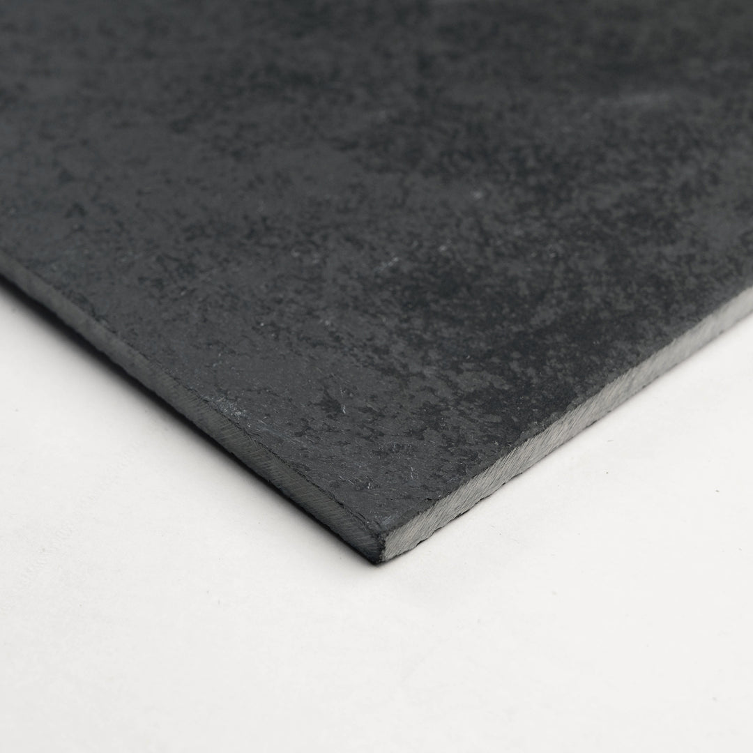 Angled view of Brazilian Black Slate 16x16 Gauged Tile, offering a uniform matte surface and bold dark tone perfect for sophisticated stone flooring.