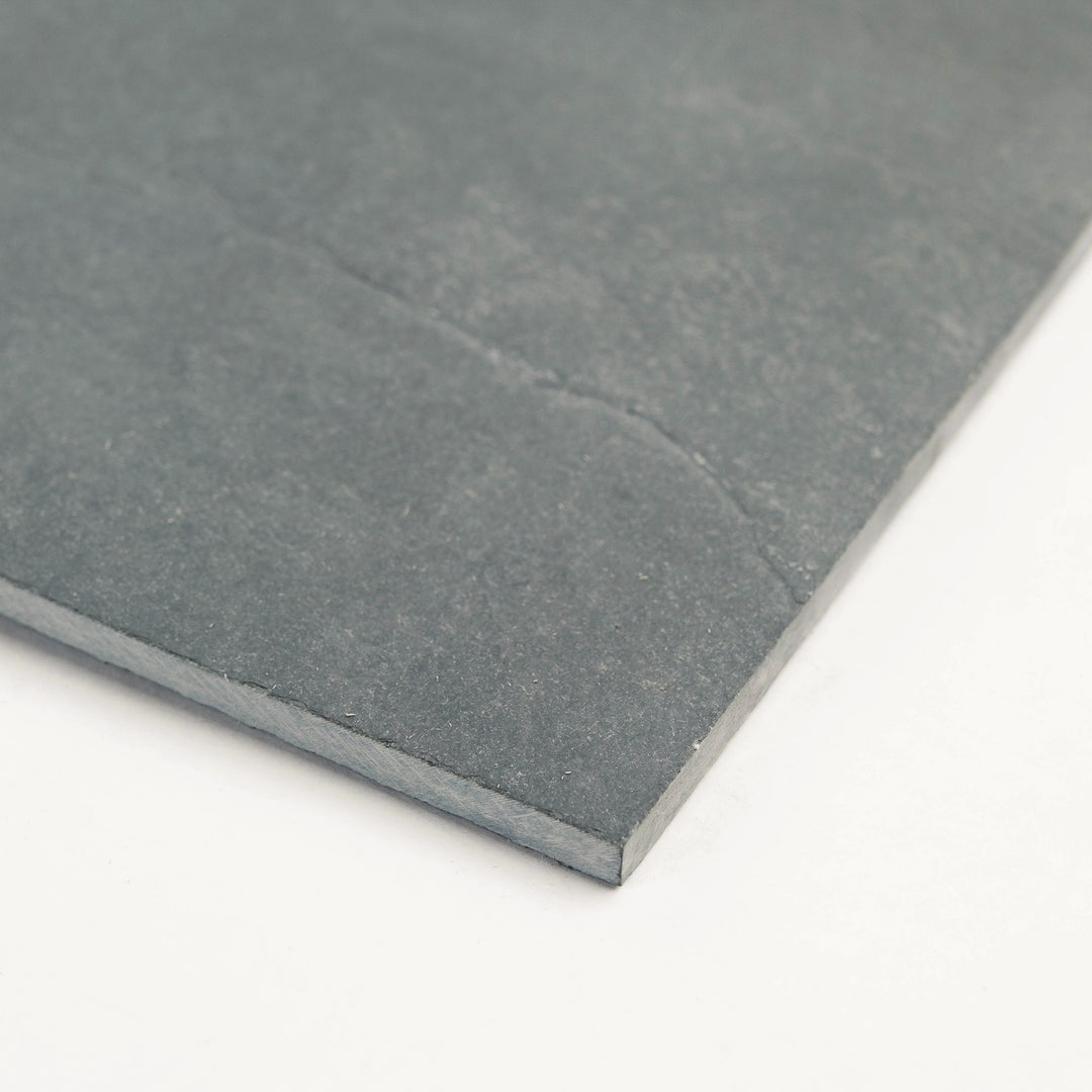 Corner shot of Brazilian Grey Slate 12x24 Gauged Tile, displaying its refined grey surface and subtle stone movement for elegant wall or floor layouts.