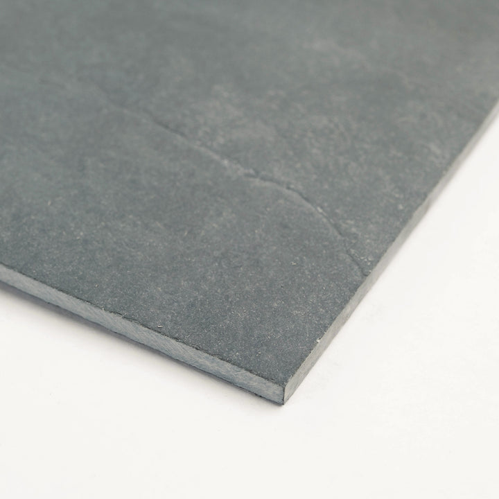 Corner shot of Brazilian Grey Slate 12x24 Gauged Tile, displaying its refined grey surface and subtle stone movement for elegant wall or floor layouts.