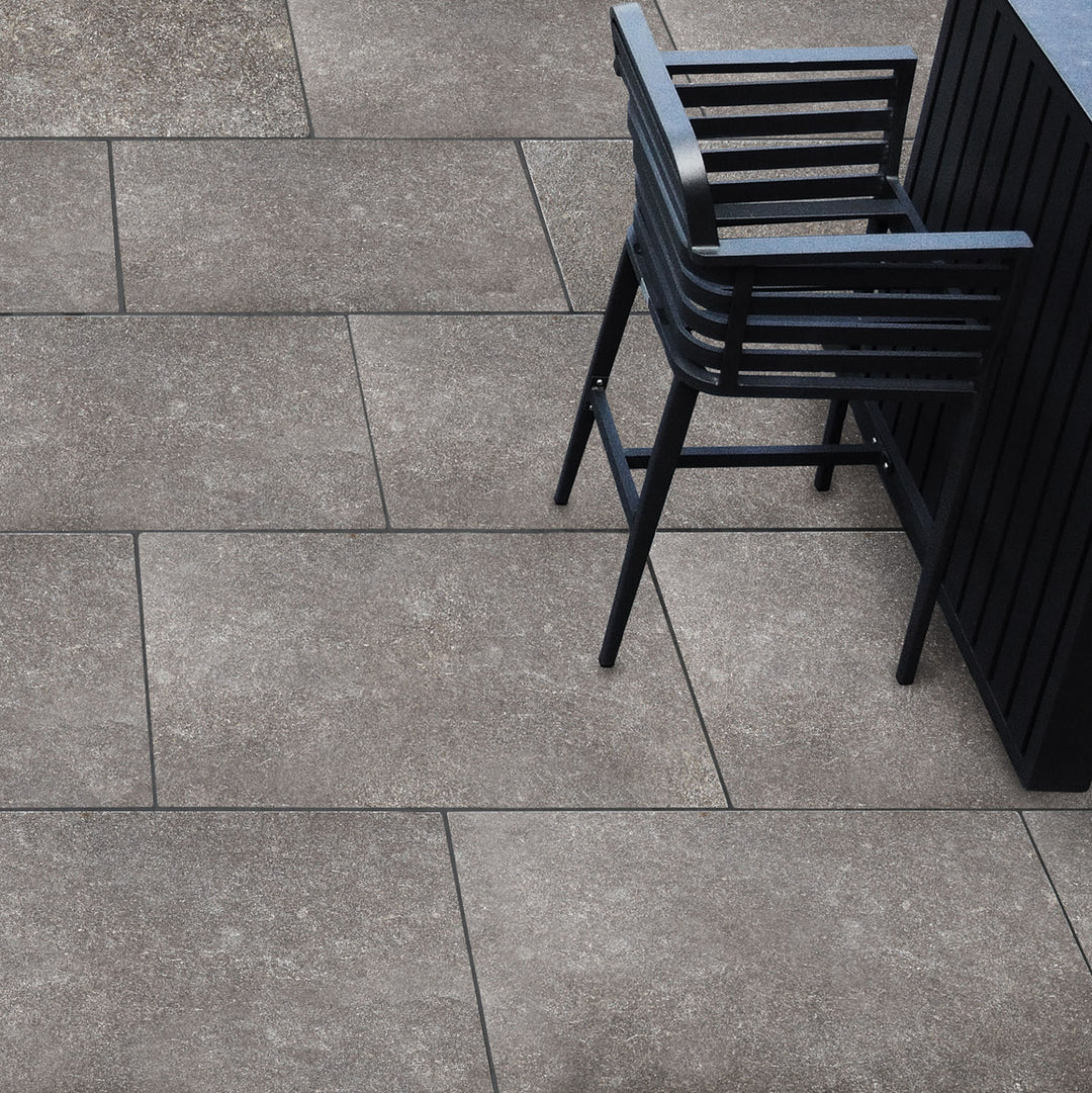 Gray tiled floor with black outdoor furniture