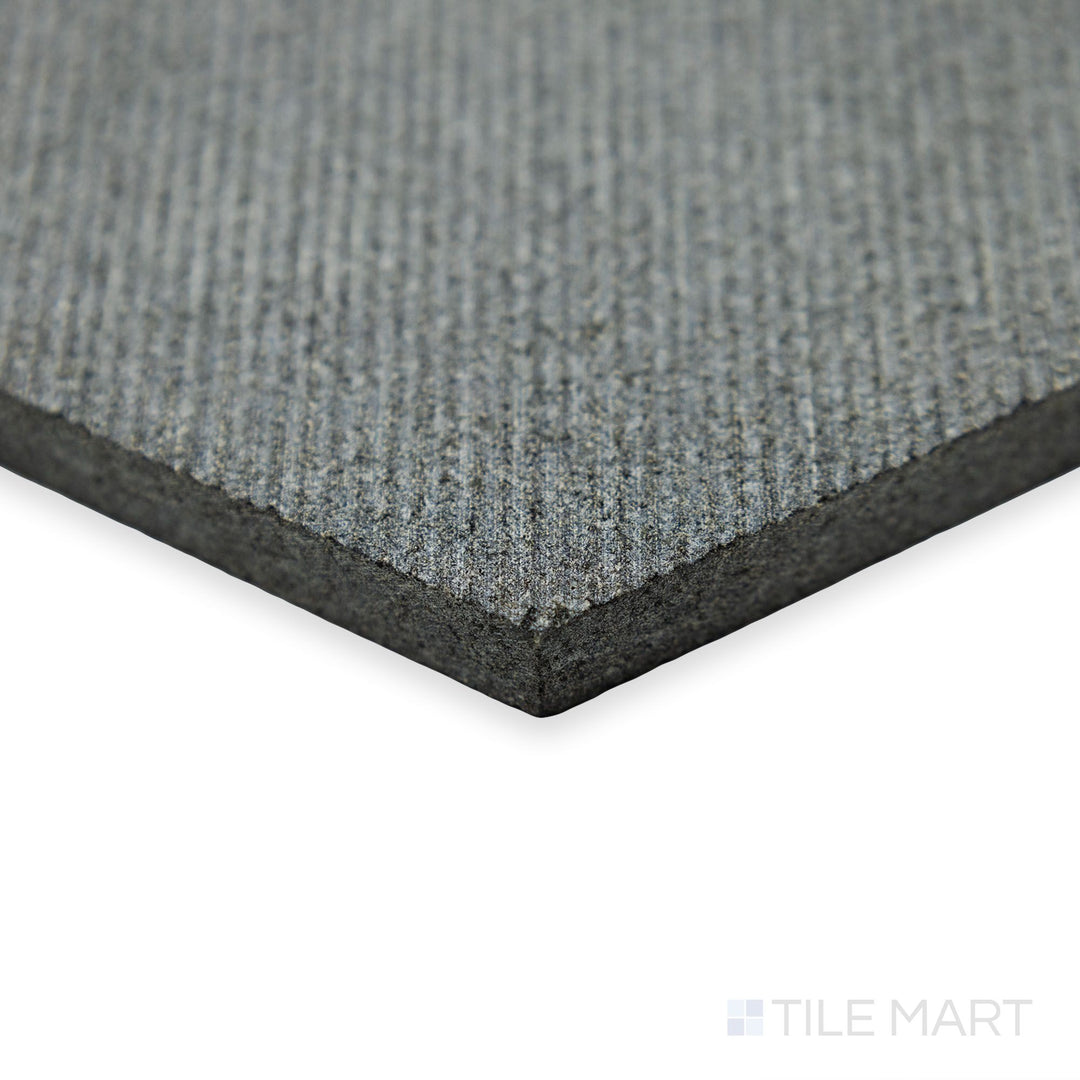 Corner focus on Basalt Black 10” Hexagon Flow tile showcasing geometric edges and smooth dark stone finish.