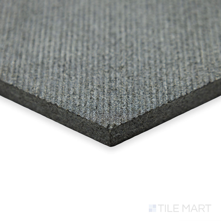 Corner focus on Basalt Black 10” Hexagon Flow tile showcasing geometric edges and smooth dark stone finish.