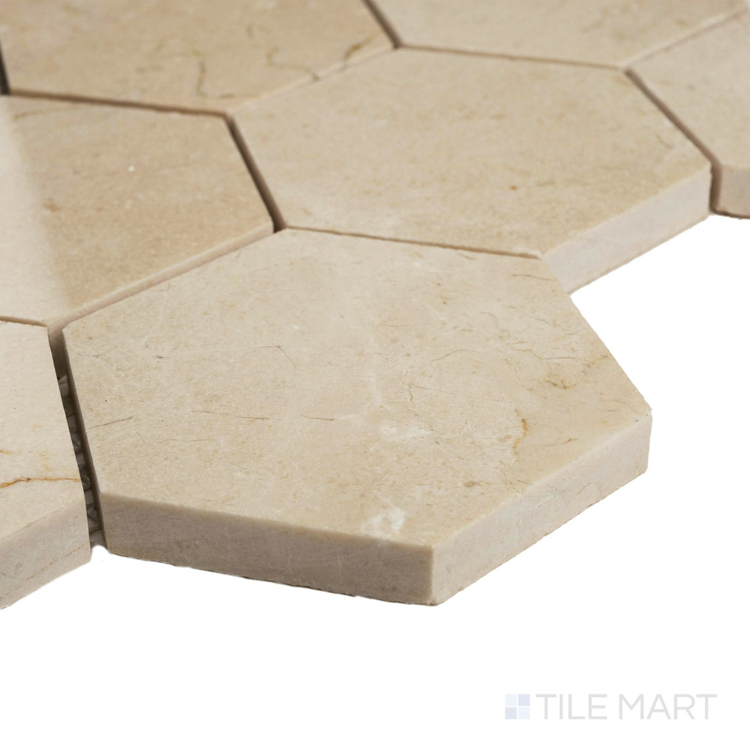 Corner close-up of Crema Marfil Marble 3” hexagon honed mosaic highlighting smooth matte texture and warm beige tone.