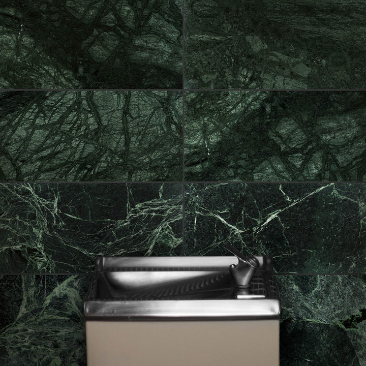 Bathroom sink with green marble wall tiles