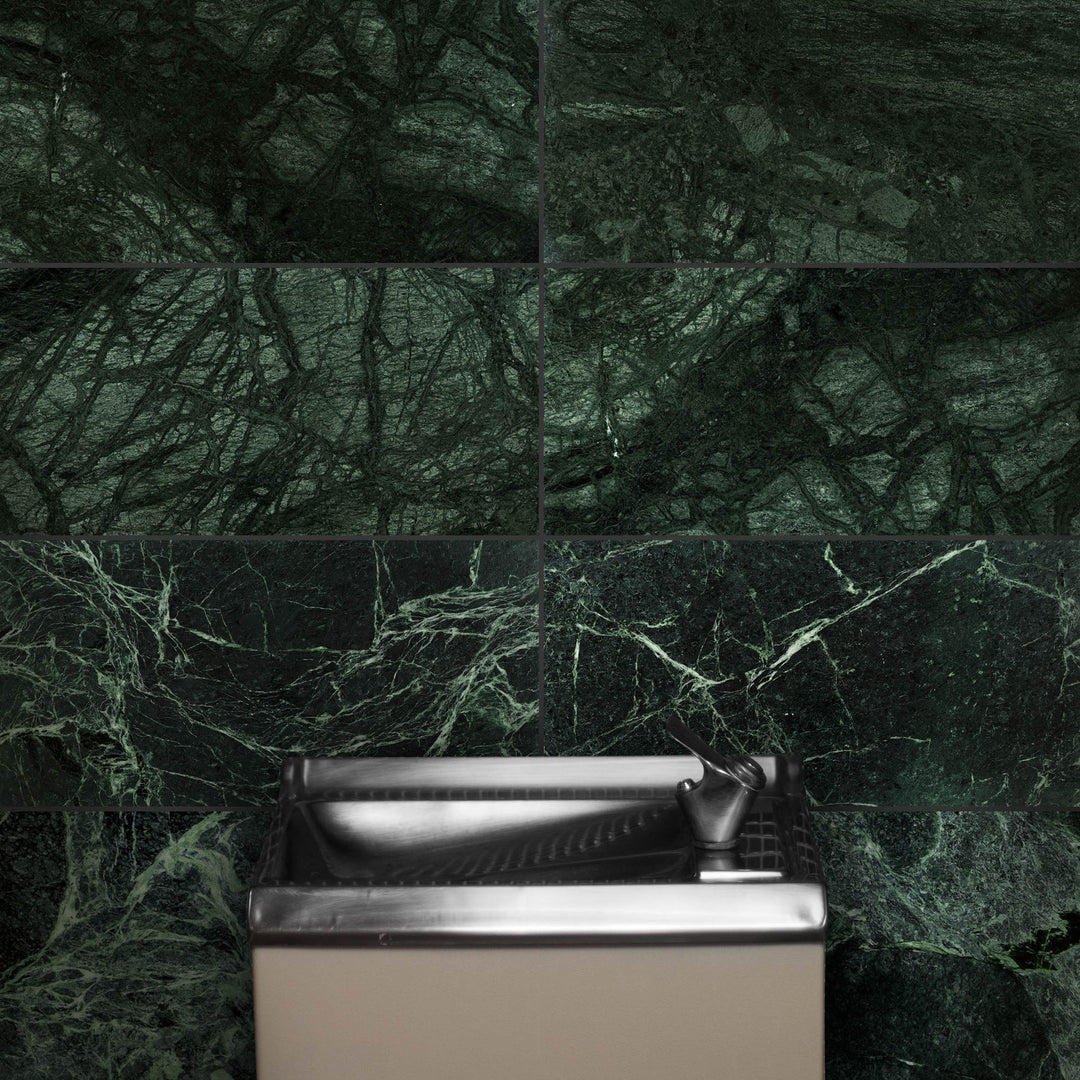 Bathroom sink with green marble wall tiles