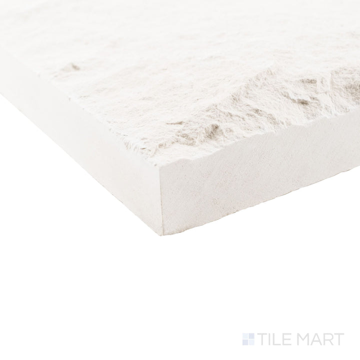 Corner view of Lymra limestone veneer in 8x random splitface pattern emphasizing rugged stone relief