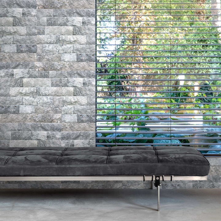 Silver travertine veneer in random splitface pattern featured in a modern interior with layered stone texture