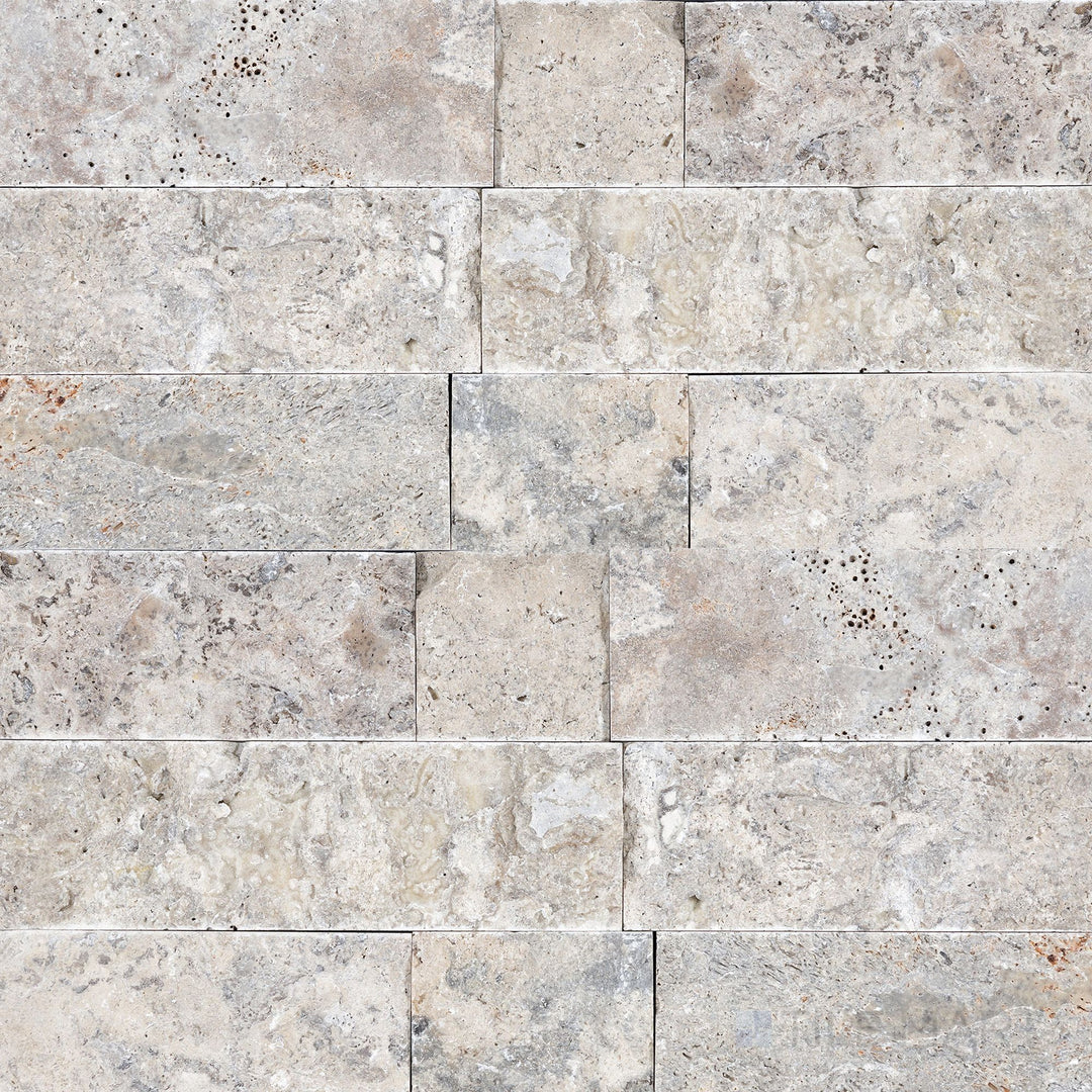 Silver travertine veneer in a 4x random splitface design highlighting layered stone texture