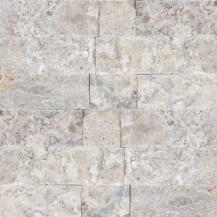 Silver travertine veneer in a 4x random splitface design highlighting layered stone texture