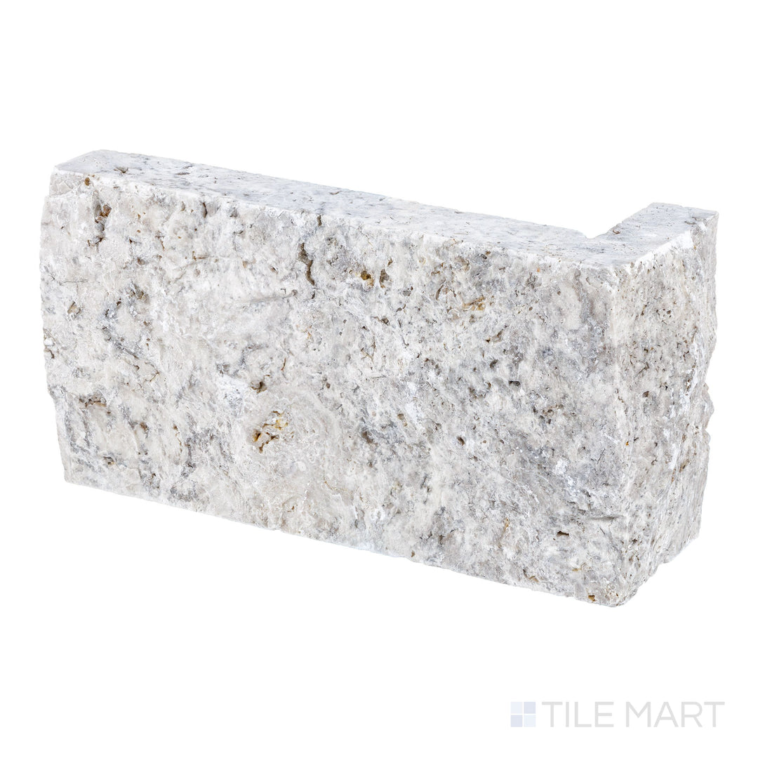 Detail of Silver travertine 4x7.5 corner veneer with dimensional splitface texture and defined edges