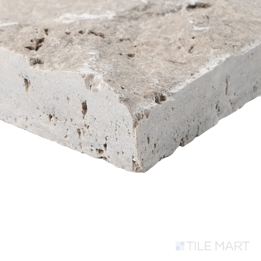 Corner detail of Silver travertine 4x7.5 corner veneer highlighting sculpted splitface texture and defined return
