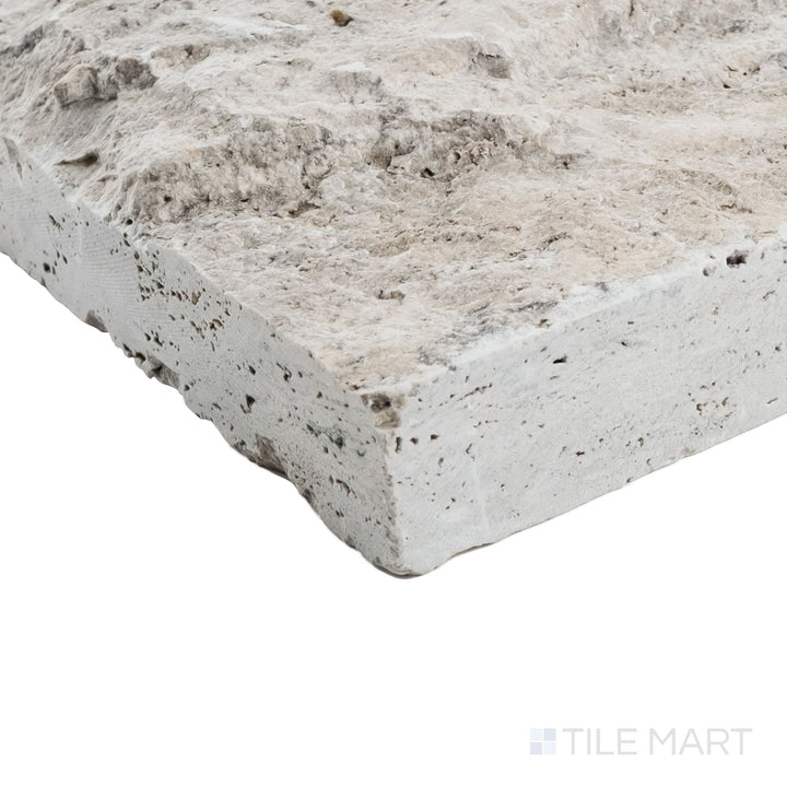 Corner view of Silver travertine veneer in 8x random splitface pattern showcasing layered stone face