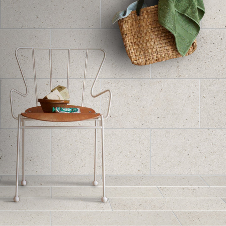 Porto Beige limestone 18x36 tile styled in a modern interior highlighting elongated scale and natural variation