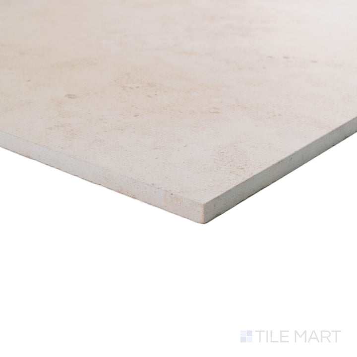 Corner detail of Porto Beige limestone 18x36 tile revealing elongated scale and refined honed texture