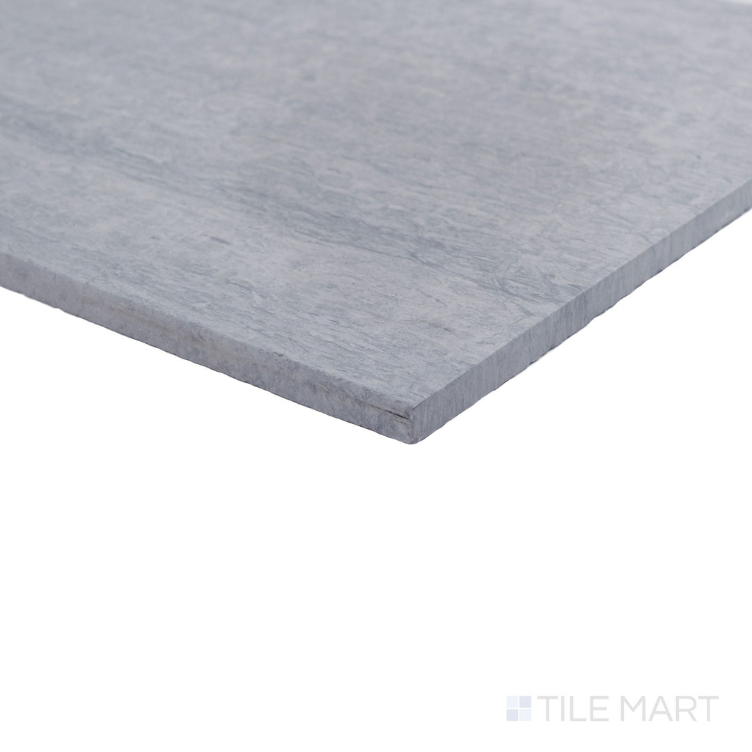 Corner view of honed Haisa Blue marble 12x24 tile highlighting flowing veining and clean edges