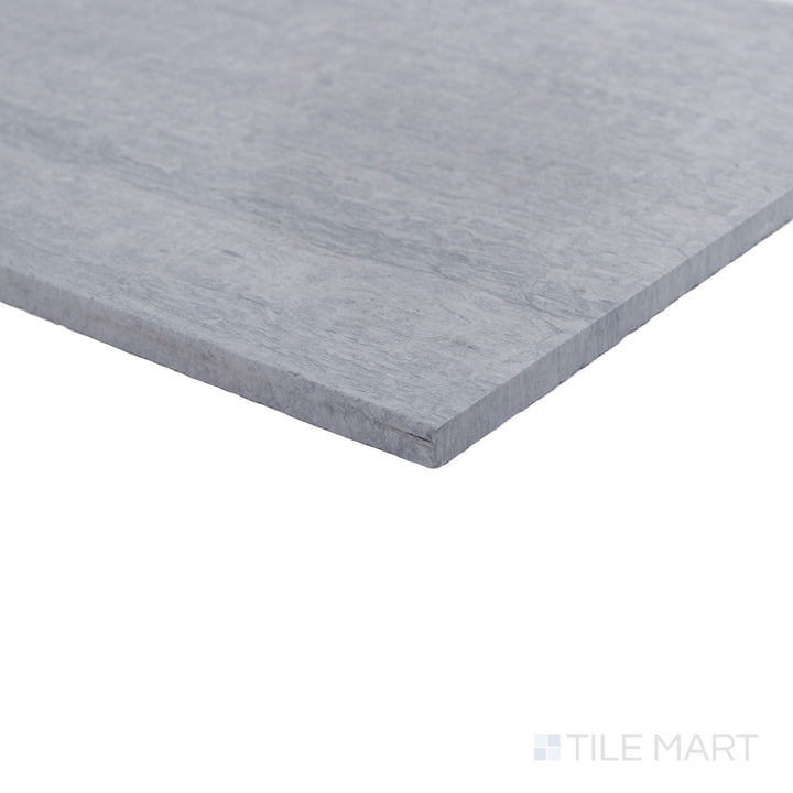 Corner view of honed Haisa Blue marble 12x24 tile highlighting flowing veining and clean edges