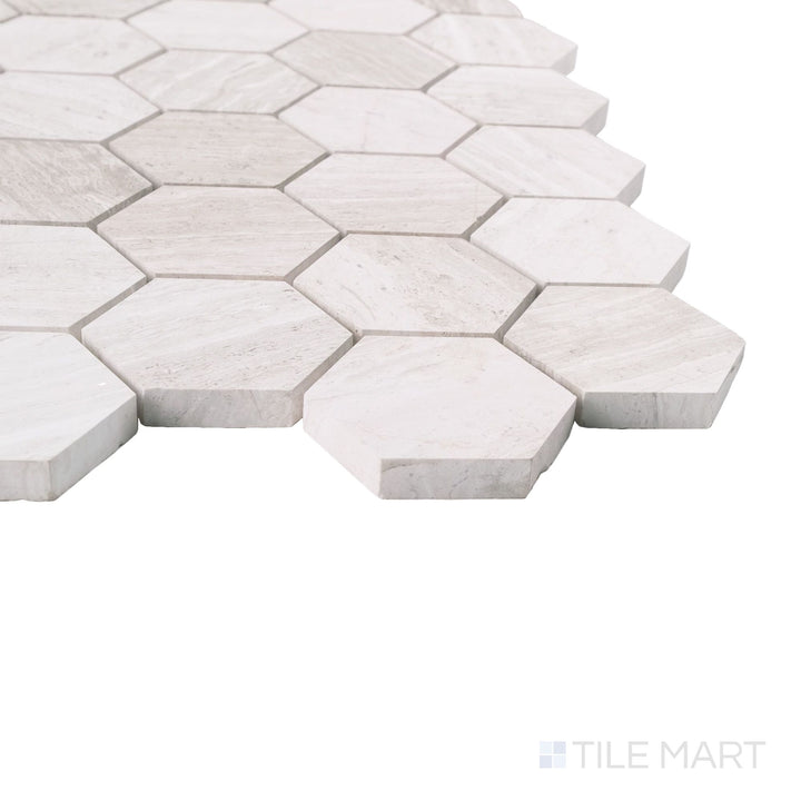 Haisa Light marble hexagon mosaic shown at corner angle with honed finish and soft geometric pattern