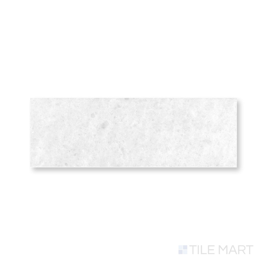 Close-up of Polar White marble 4x12 tile with honed finish and gentle natural veining