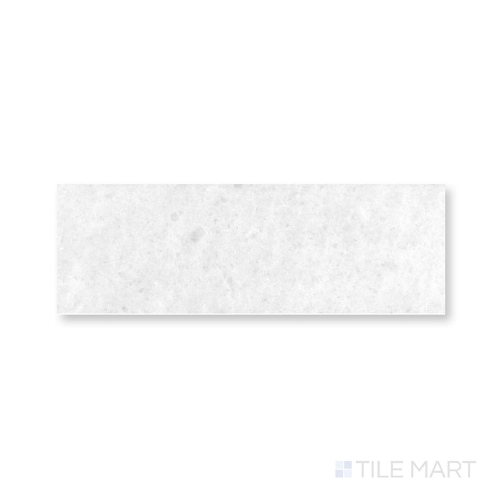 Close-up of Polar White marble 4x12 tile with honed finish and gentle natural veining