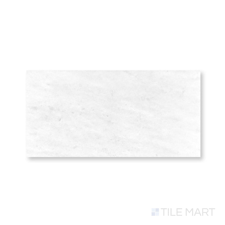 Close view of Polar White marble 6x12 tile with honed finish and soft linear stone pattern