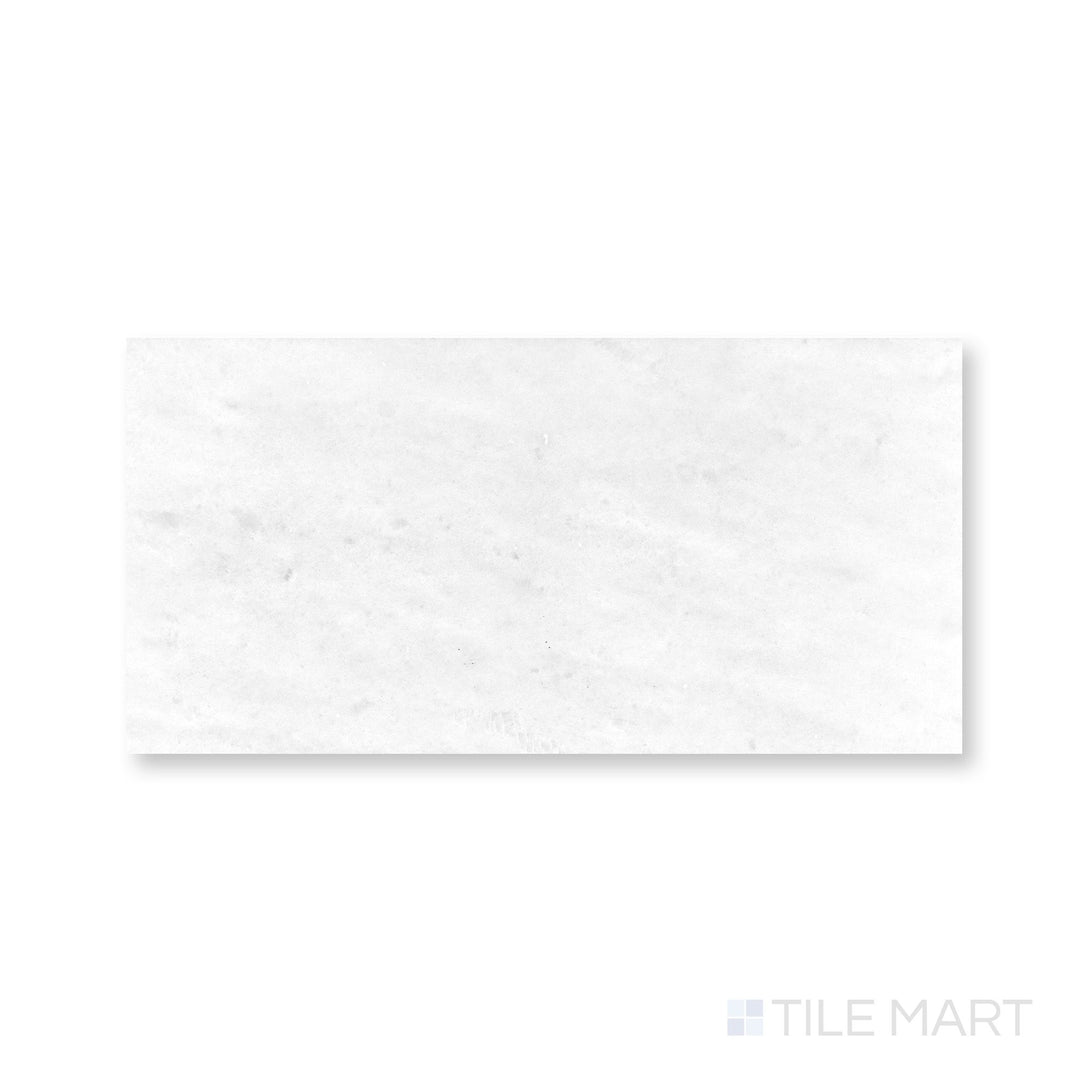 Top-down detail of Polar White marble 12x24 tile with honed finish and soft linear veining
