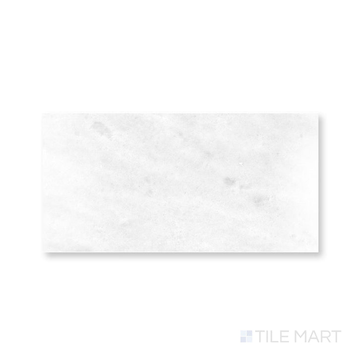 Close-up of Polar White marble 12x24 tile showcasing polished surface and soft linear veining