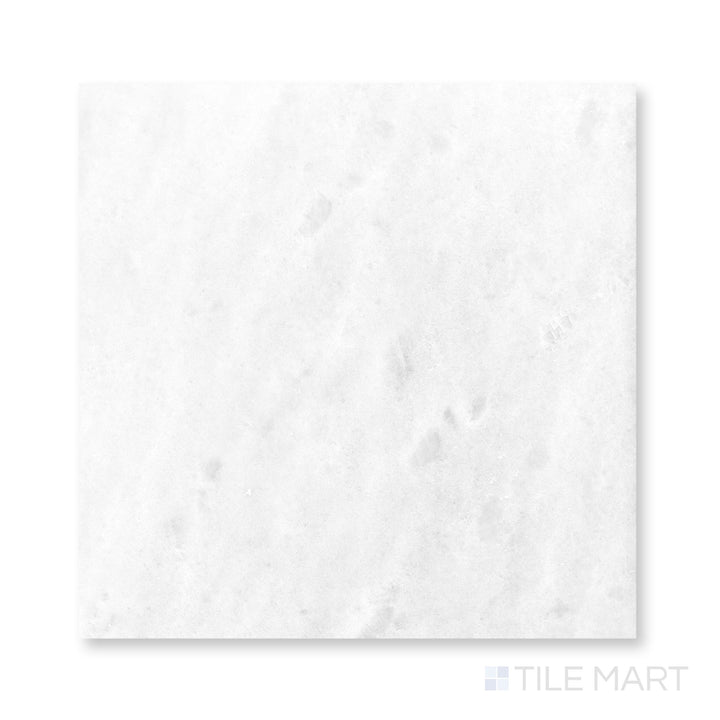 Top-down close view of Polar White marble 24x24 tile revealing polished finish and luminous stone character