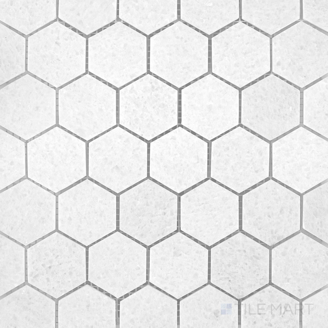 Polar White marble mosaic with a honed finish and soft geometric stone pattern