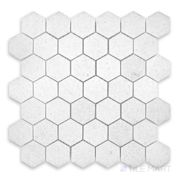 Close-up of Polar White marble mosaic with honed finish and soft geometric stone pattern