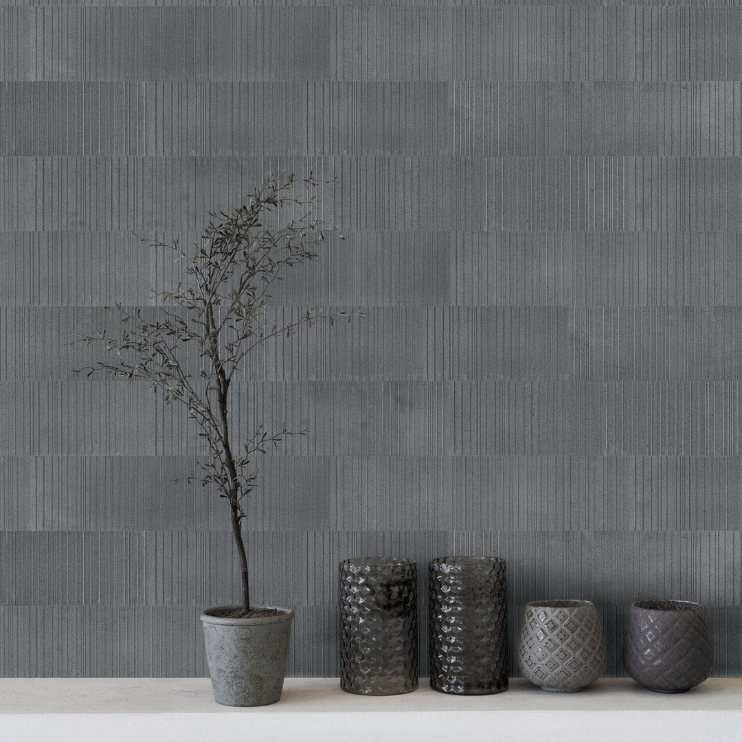 Ravello Black basalt 6x24 fence tile featured in a modern interior with bold linear texture