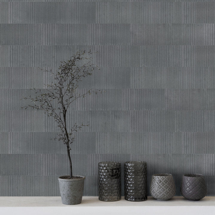 Ravello Black basalt 6x24 fence tile featured in a modern interior with bold linear texture