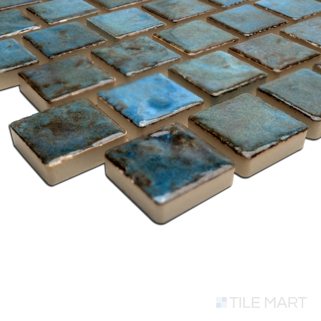 Angled view focusing on the details of JOYA 100 ALBI 1X1, capturing the precision-cut edges and rich texture of the PORCELAIN material. The clean lines provide a sharp, polished look for intricate tiling projects.