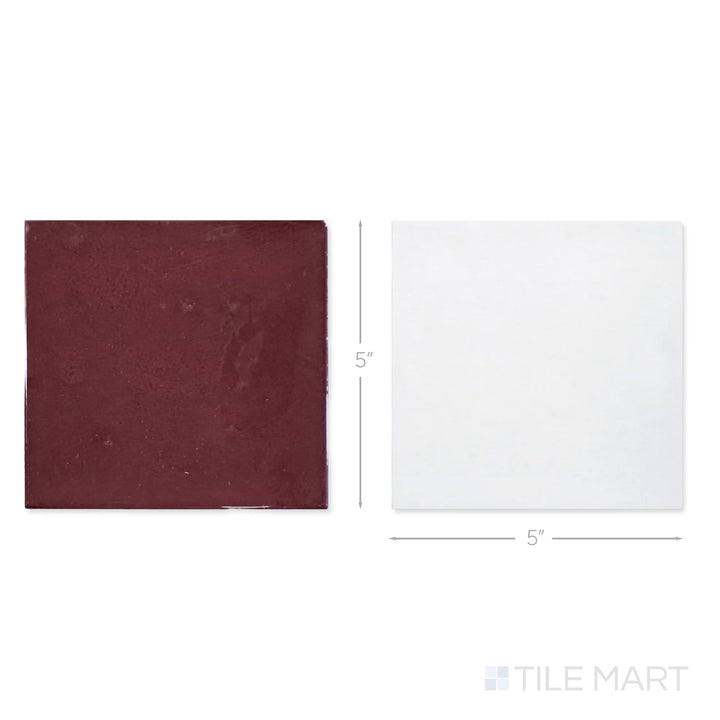 Top-down view of a single Village 5x5 white and aubergine checkerboard glossy ceramic tile showing its light-reflective surface and two-tone finish detail