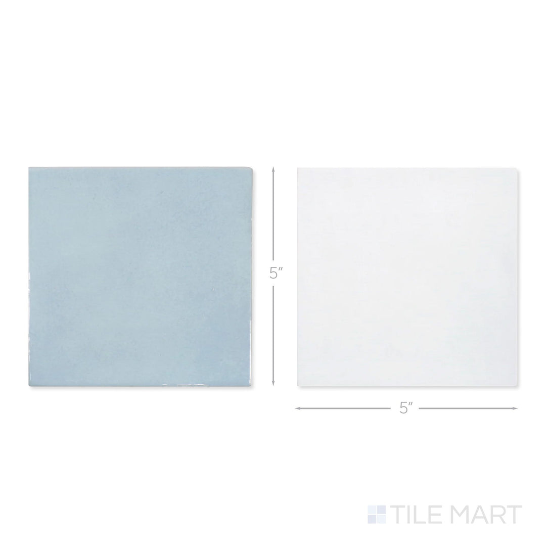 Top-down view of a single Village 5x5 white and cloud checkerboard glossy ceramic tile showing its light-reflective surface and two-tone finish detail