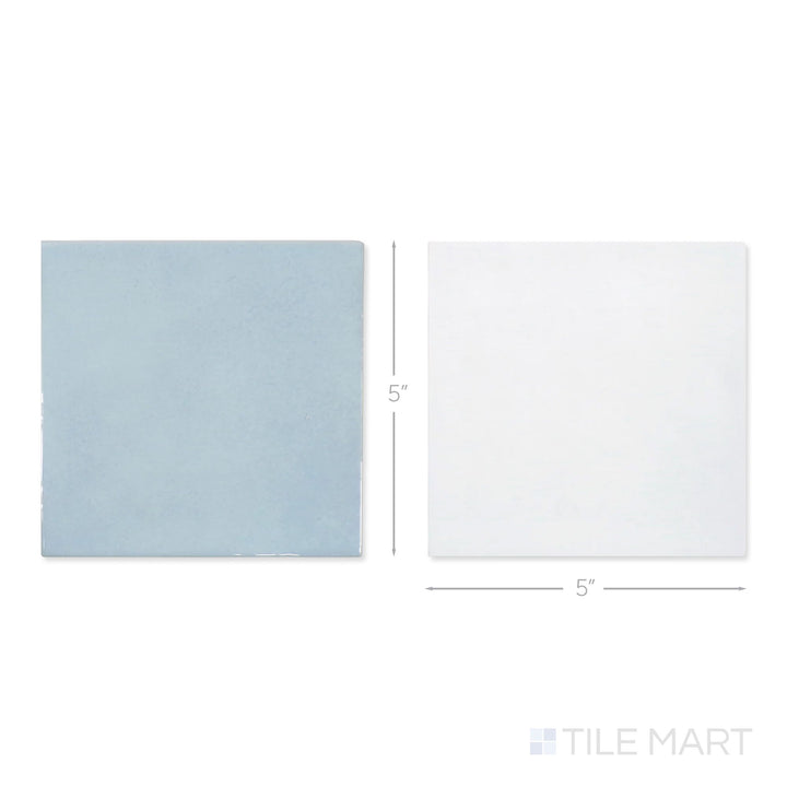 Top-down view of a single Village 5x5 white and cloud checkerboard glossy ceramic tile showing its light-reflective surface and two-tone finish detail