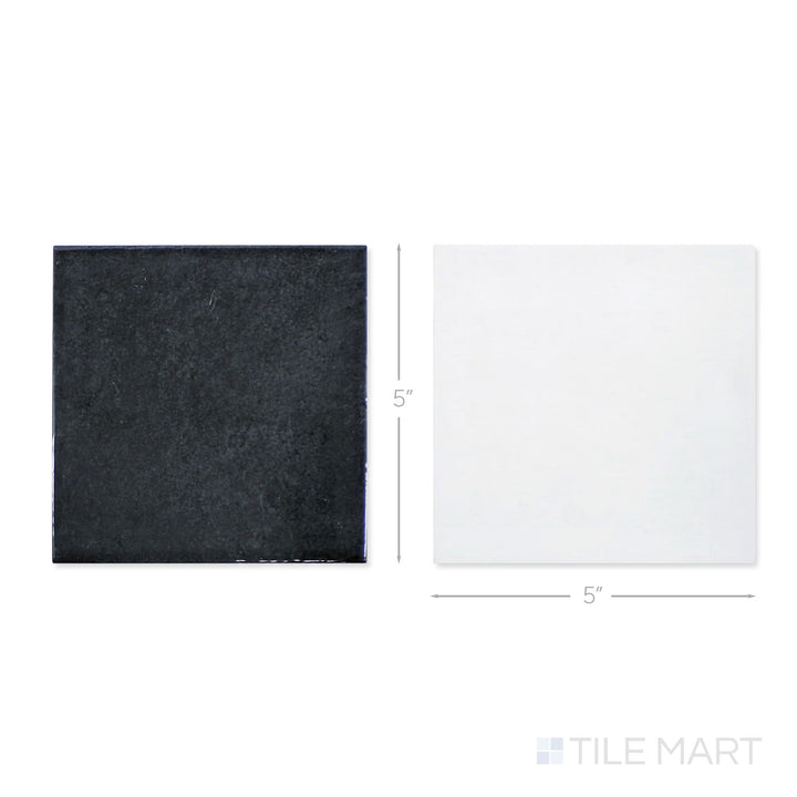 Top-down view of a single Village 5x5 white and black checkerboard glossy ceramic tile showing its light-reflective surface and two-tone finish detail
