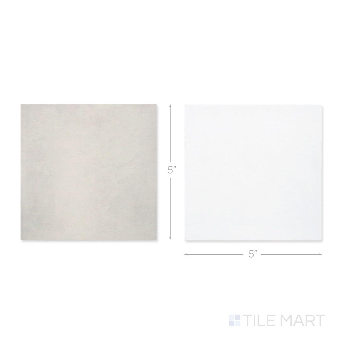Top-down view of a single Village 5x5 white and silver mist checkerboard glossy ceramic tile showing its light-reflective surface and two-tone finish detail